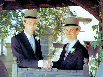 Two top hats at the church gate - Kit's wedding