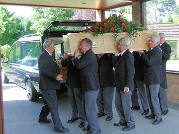 Ian's coffin is brought in