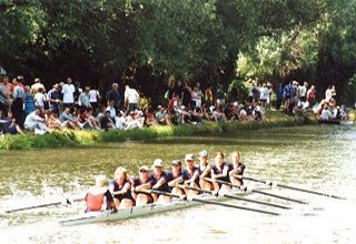 Crowds cheer on a college boat