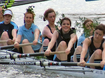 A crew rows back bedecked with foliage, after making their bump